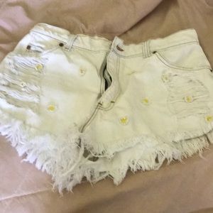 White distressed shorts with daisies